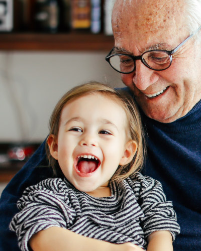Grandfather joyfully holding a grandchild