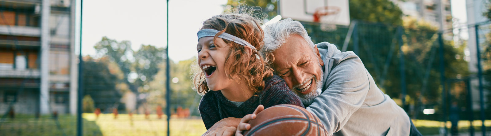 Grandfather  playing basketball with grandson